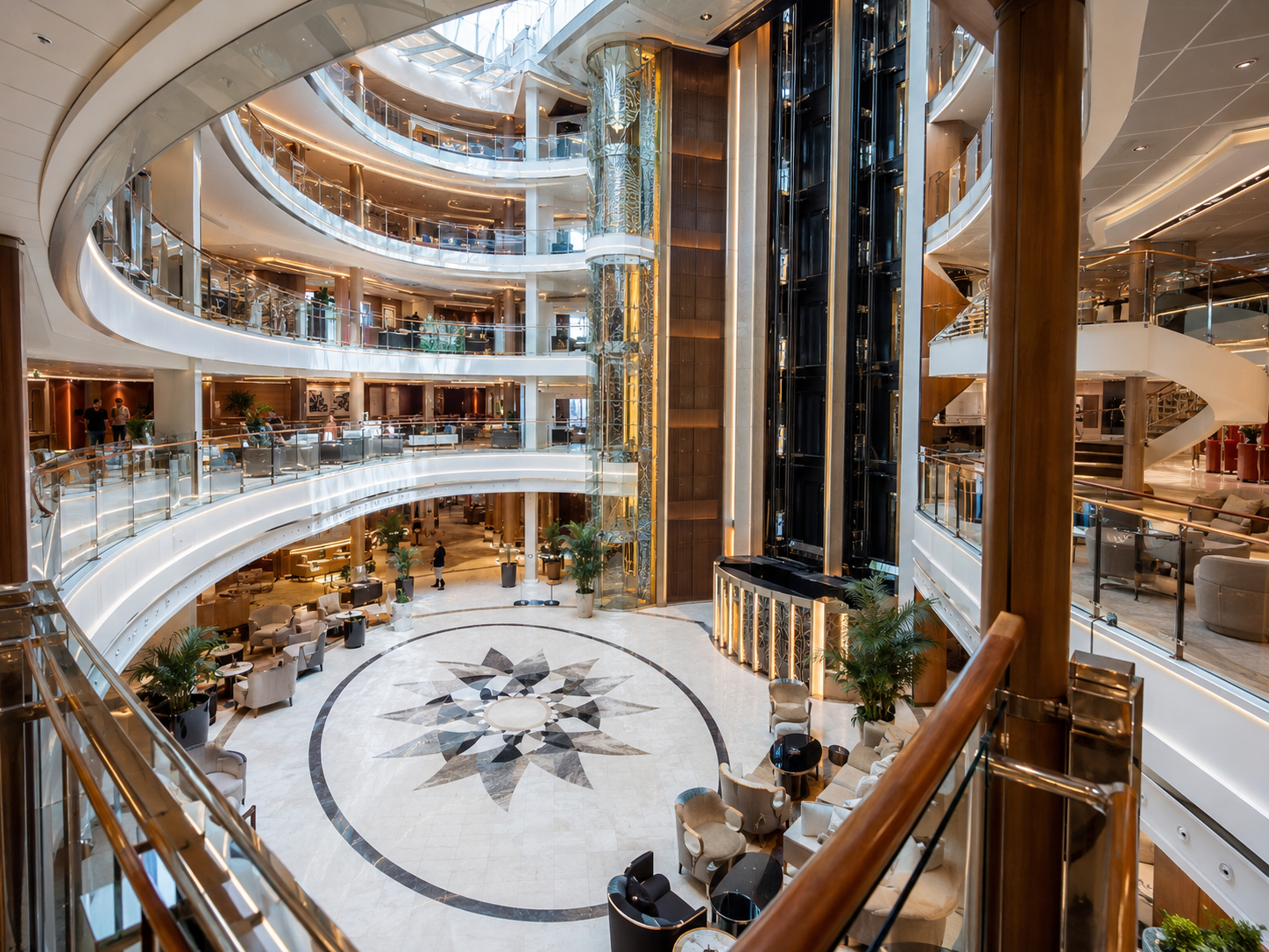 A bright, open multi-deck atrium inside a modern cruise ship